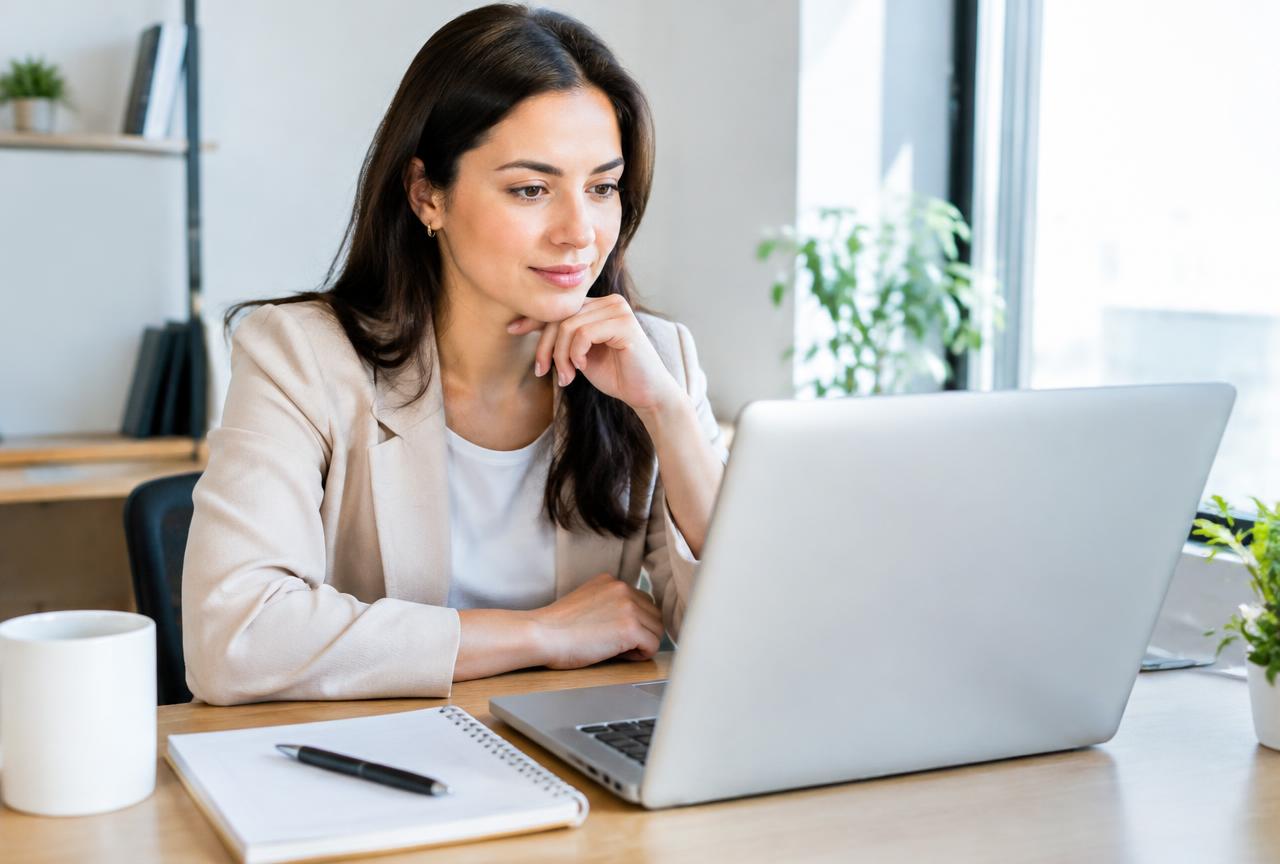 Professional optimising a LinkedIn profile on a laptop for personal branding and career visibility